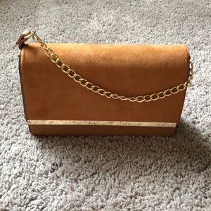 Tan crossbody with gold details.